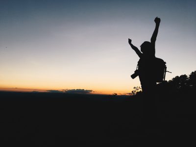 Silhouette man sunset or sunrise in mountain with copy space.